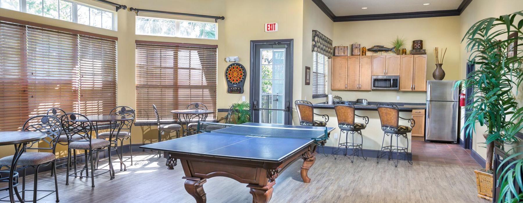 a large room with a pool table and chairs