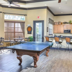 a large room with a pool table and chairs