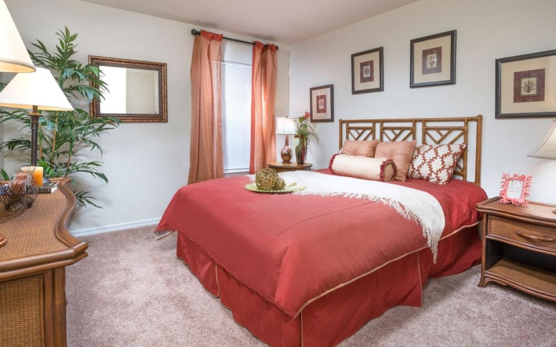 a bedroom with a bed and lamps