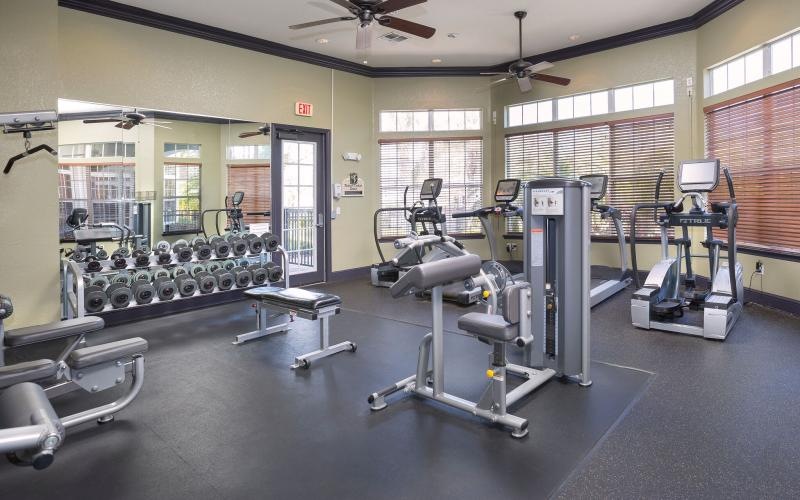 a room with treadmills and a fan