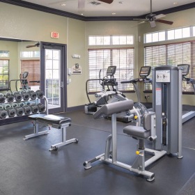 a room with treadmills and a fan